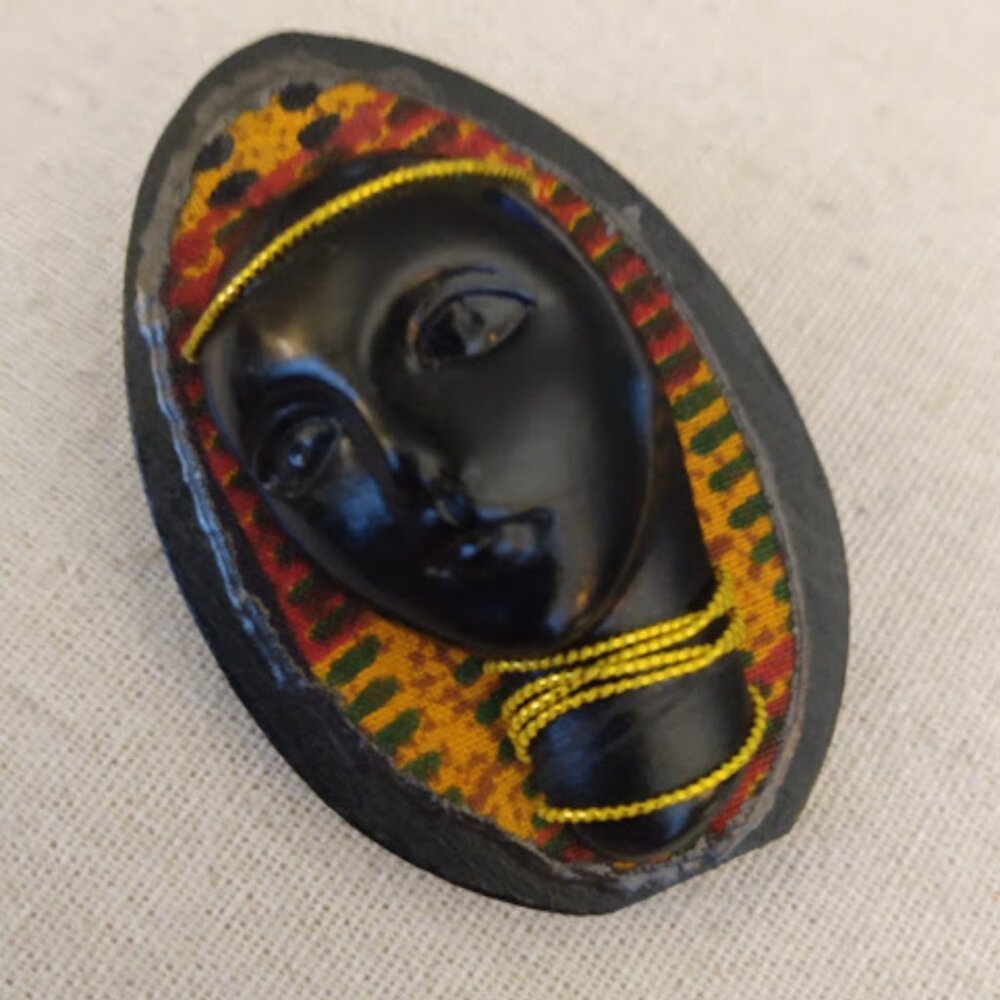 African Lady brooch/pin on wood base. Marked Lindee.